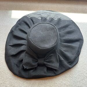 Dark black/grey hat. No brand listed